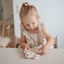 Brinquedo Para Prensar Mushie Flores Soft Lilac/ Daffodil/ Ivory