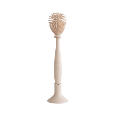 Escova de silicone para mamadeiras Mushie com areia movediça